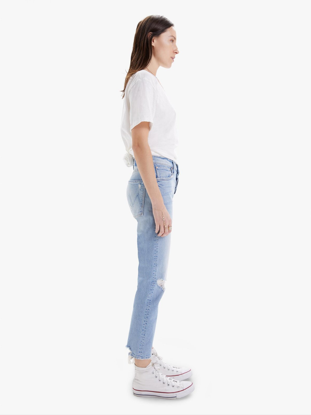 MOTHER denim jeans. Side view of The Scrapper Ankle in Bless you Again blue with rips