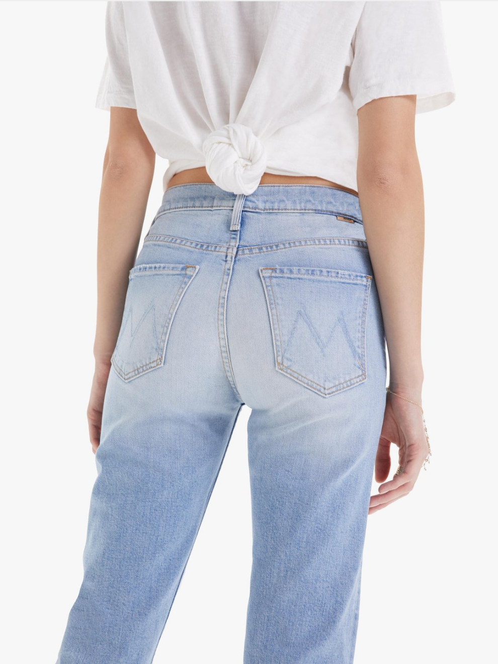 MOTHER denim jeans. Back view of The Scrapper Ankle in Bless you Again blue with rips