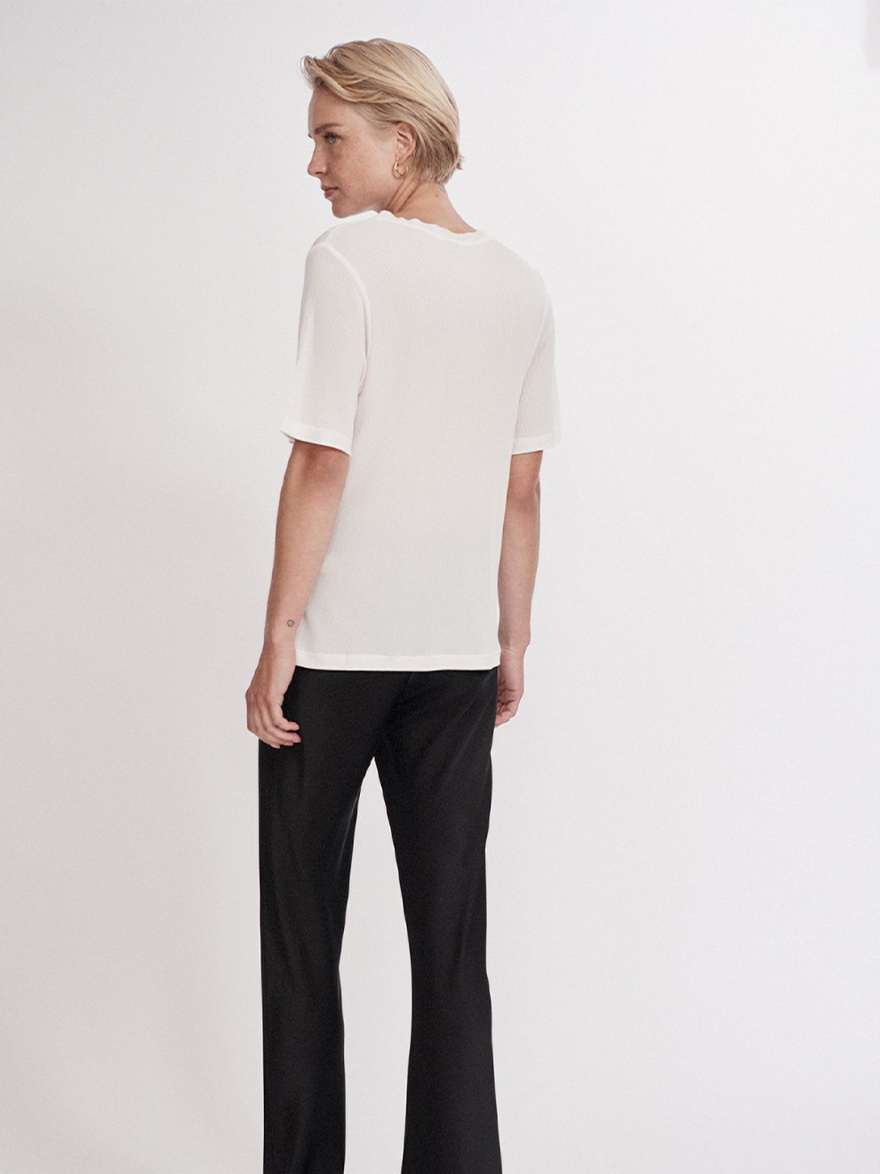 Back view of Silk White Ribbed T-shirt by Silk Laundry worn with Black bias cut Pants
