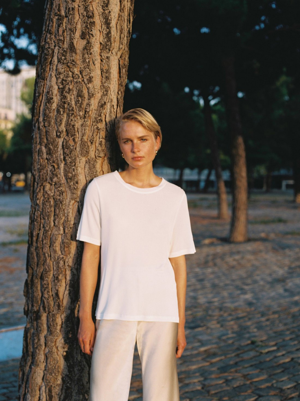 Model shot of Silk White Ribbed T-shirt by Silk Laundry worn with Bias Cut Pants in Hazelnut